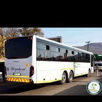 Rear and side view of a white Mabirimisa bus